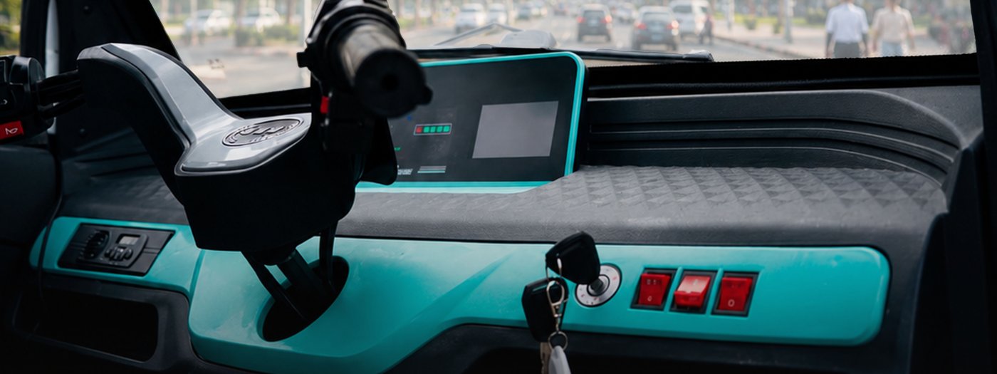 Interior view of a Mobility Ventures electric vehicle, showing the digital dashboard display on a Dar es Salaam street.