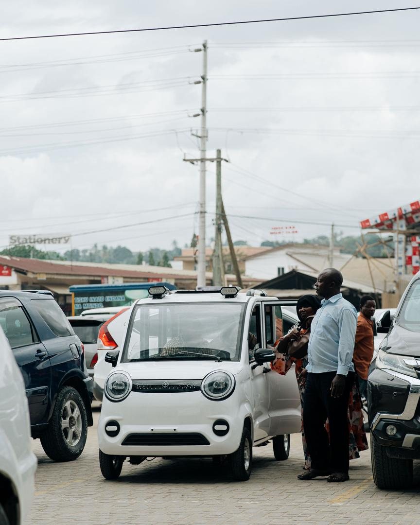 Passengers boarding a Mobility Ventures vehicle on a busy Dar es Salaam street.
