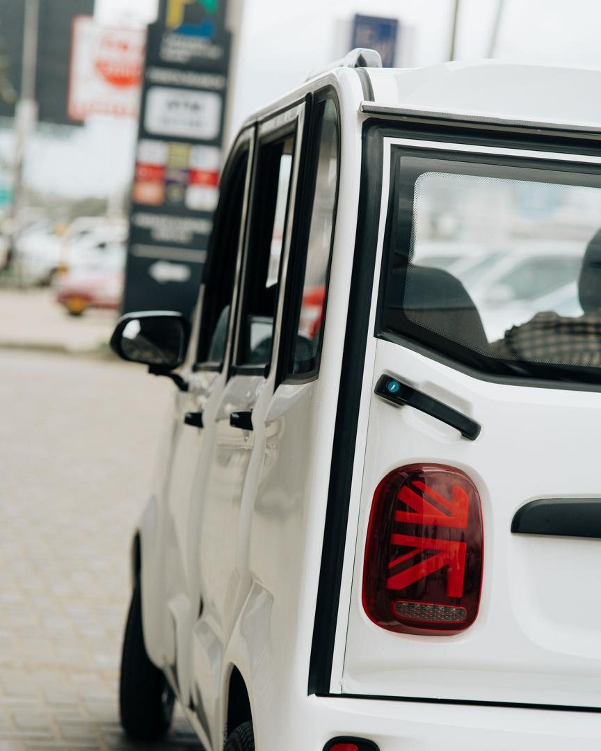 Rear three-quarter close-up of a Mobility Ventures vehicle showing the taillight and door.